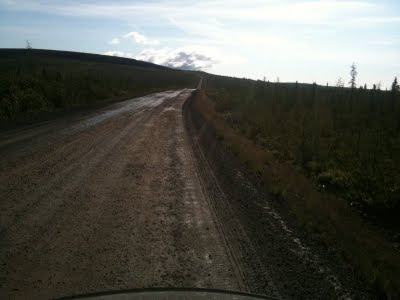 A long dirt road travelling away into the distance