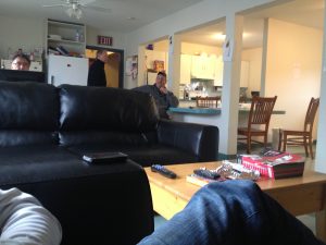 Image of several people relaxing around a living room setup inside the ferry station