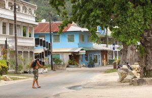 Image of locals walking down the streets of an uncrowded Huahine
