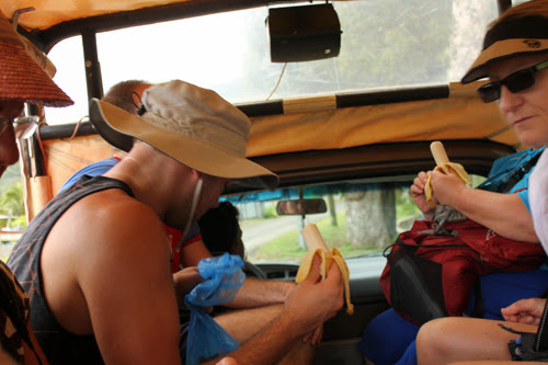 Image of everyone sitting in the back of the Jeep eating bananas