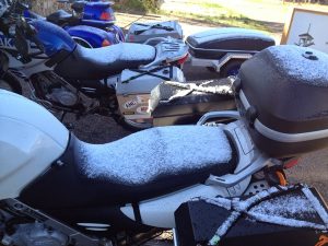 Image of a motorcycle covered in a light layer of snow