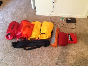 Image of several colorful sacks of gear lined up in a row
