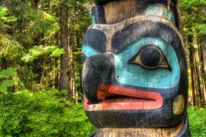 Image of a blue bird face on the top of a totem pole